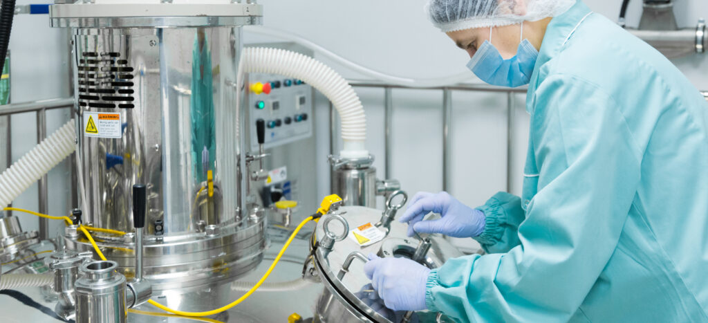 Pharmaceutical technician in sterile environment at pharmacy industry